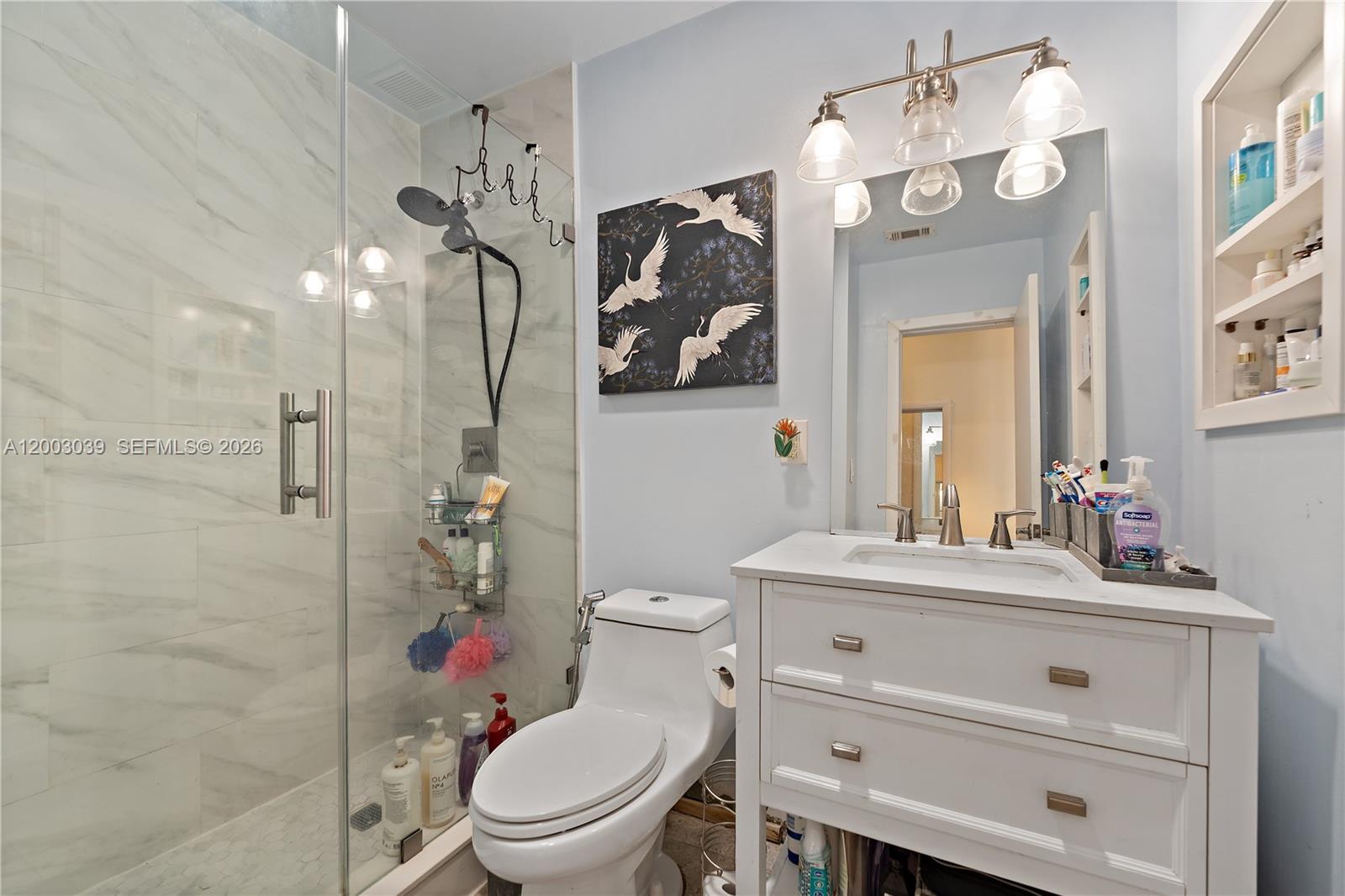 3921 Southwest 124th Court Miami, FL 33175 - Photo 13 of 22 a bathroom with a toilet a sink and a mirror