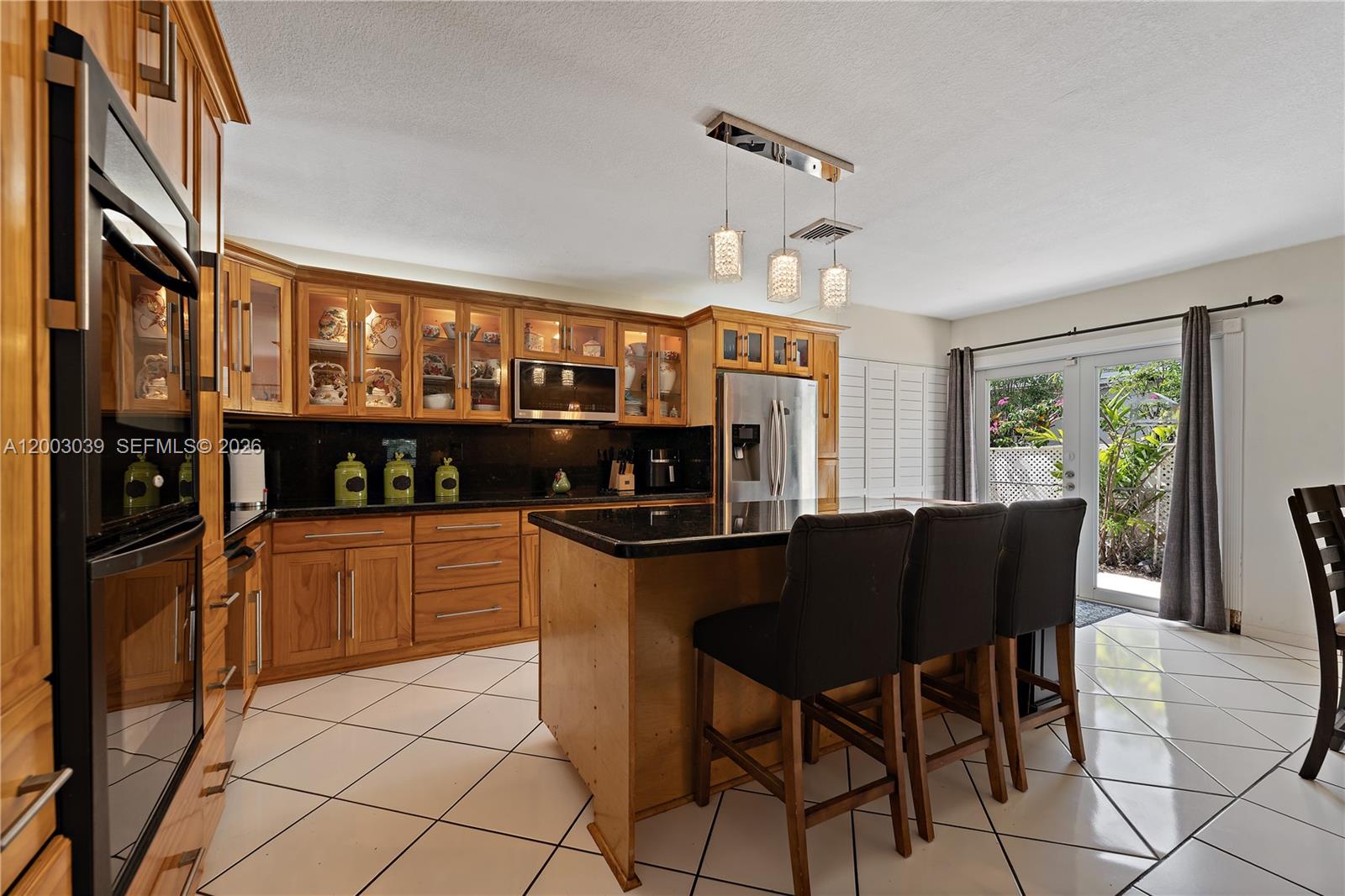 3921 Southwest 124th Court Miami, FL 33175 - Photo 9 of 22 a kitchen with stainless steel appliances granite countertop a stove top oven a sink a dining table and chairs