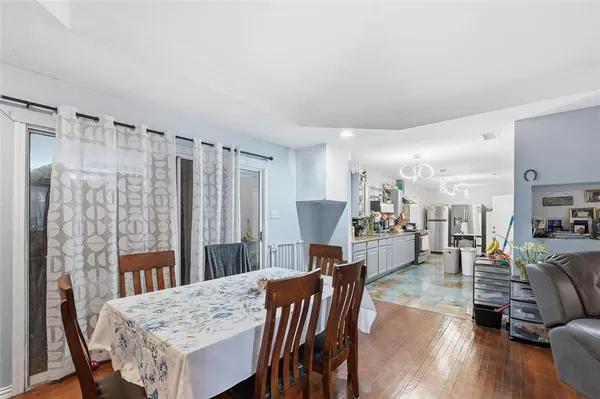 a dining room with furniture and wooden floor