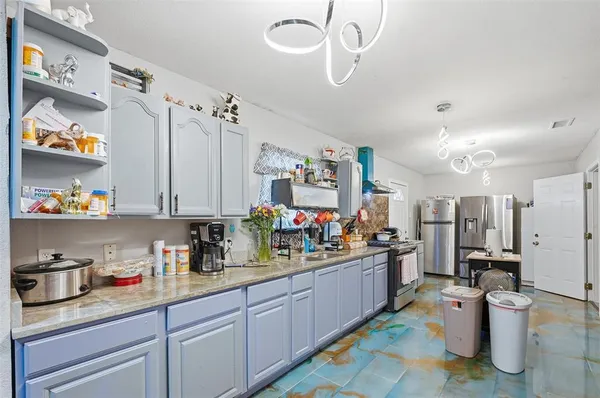 a kitchen with lots of counter top space and appliances