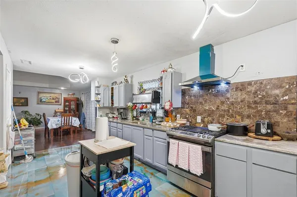 a kitchen with stainless steel appliances kitchen island granite countertop a sink and cabinets