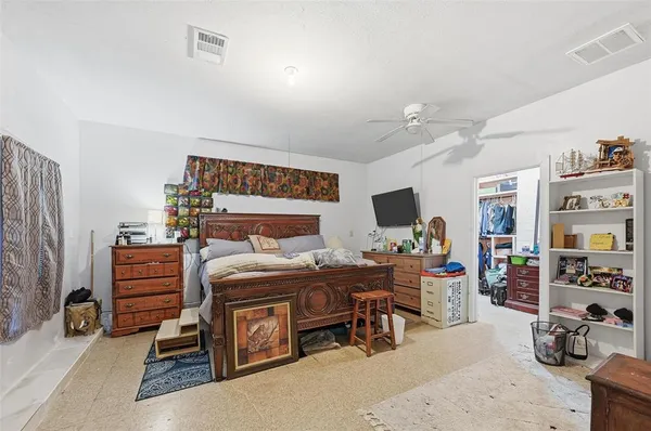 a bedroom with furniture and a flat screen tv