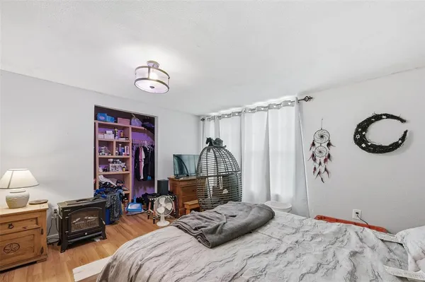 a bedroom with a bed dresser and a window