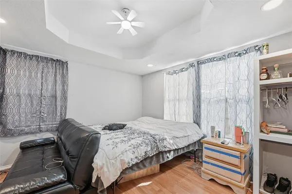 a bedroom with a bed and a chandelier