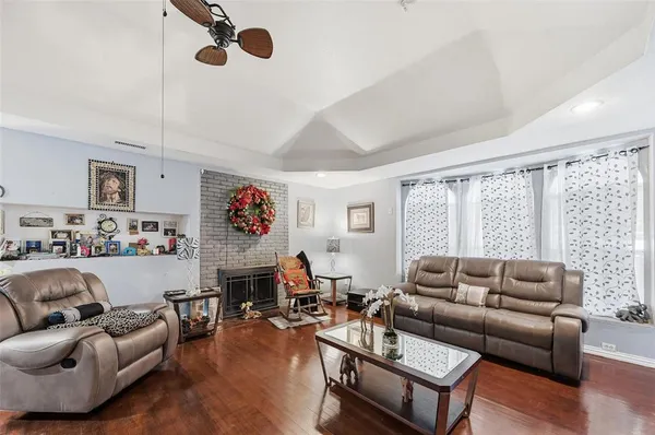 a living room with furniture kitchen view and a window