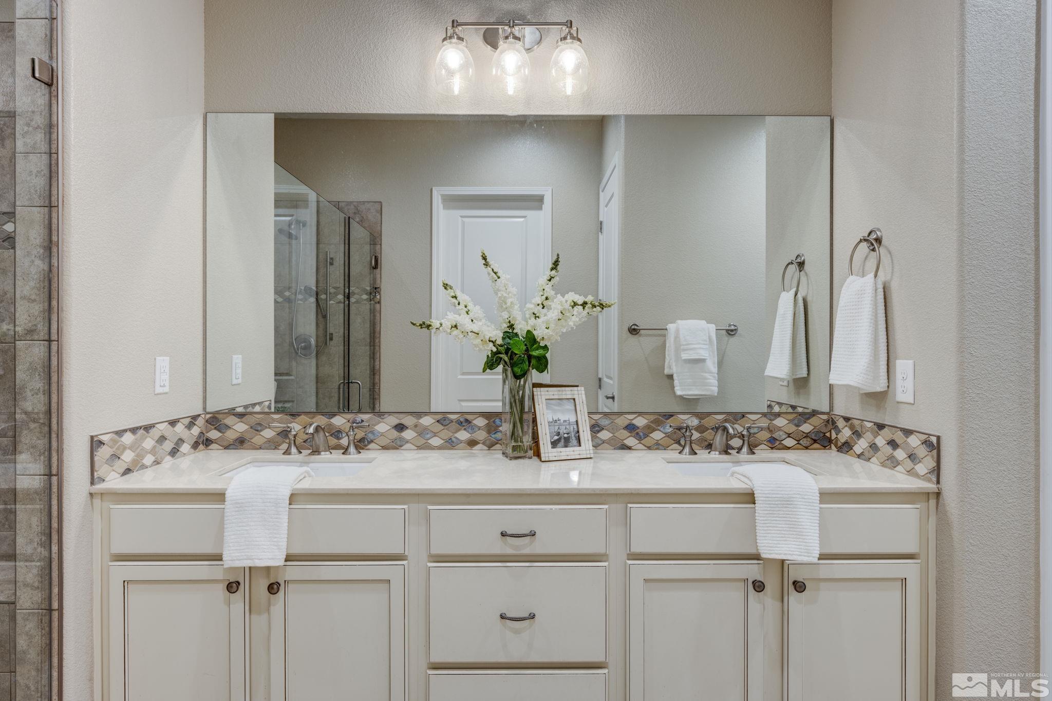 9665 Thesolious Lane Reno, NV 89521 - Photo 17 of 39 a bathroom with a sink and a mirror