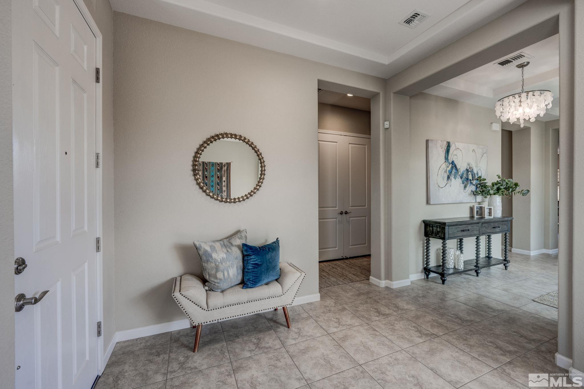 9665 Thesolious Lane Reno, NV 89521 - Photo 3 of 39 a living room with furniture and a chandelier