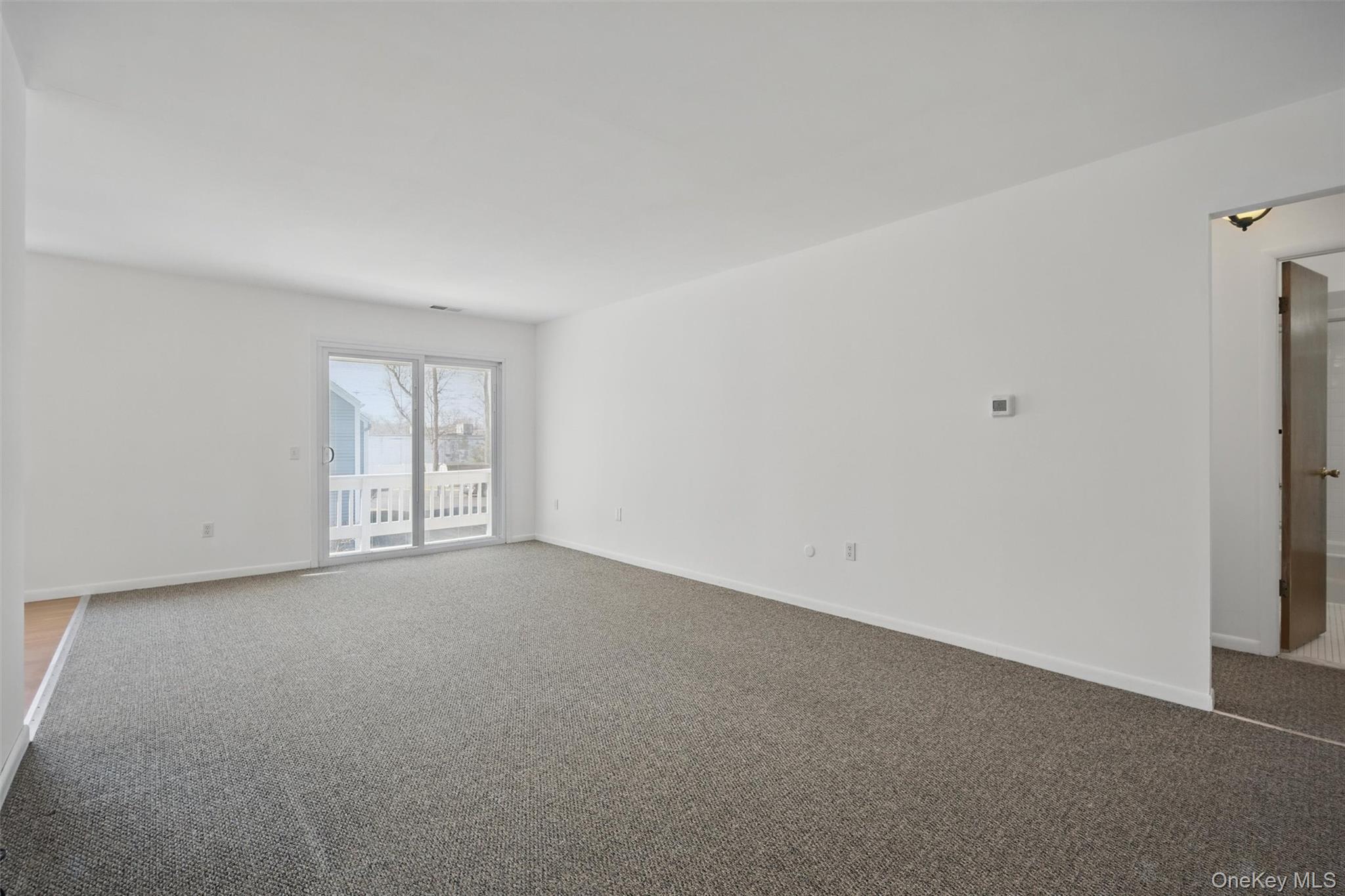 201 Commons Way, Unit E Fishkill, NY 12524 - Photo 5 of 30 Empty room featuring carpet floors
