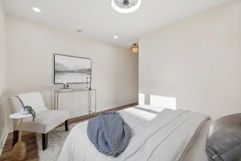 a bedroom with a bed and a painting on the wall