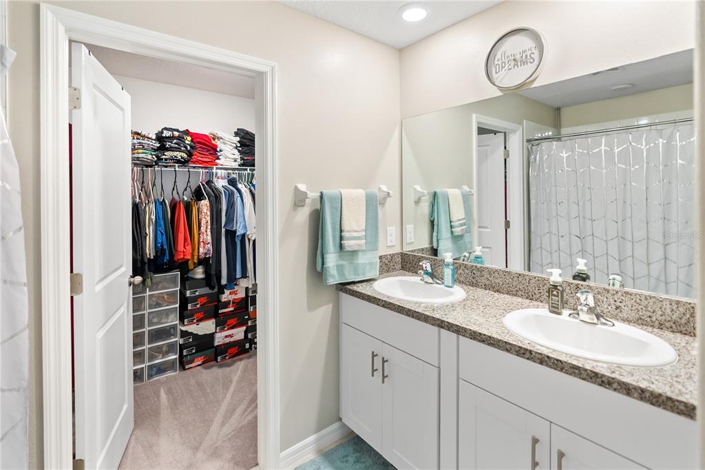 9313 Lemon Drop Loop Ruskin, FL 33573 - Photo 13 of 29 a view of a bathroom with a sink and a mirror