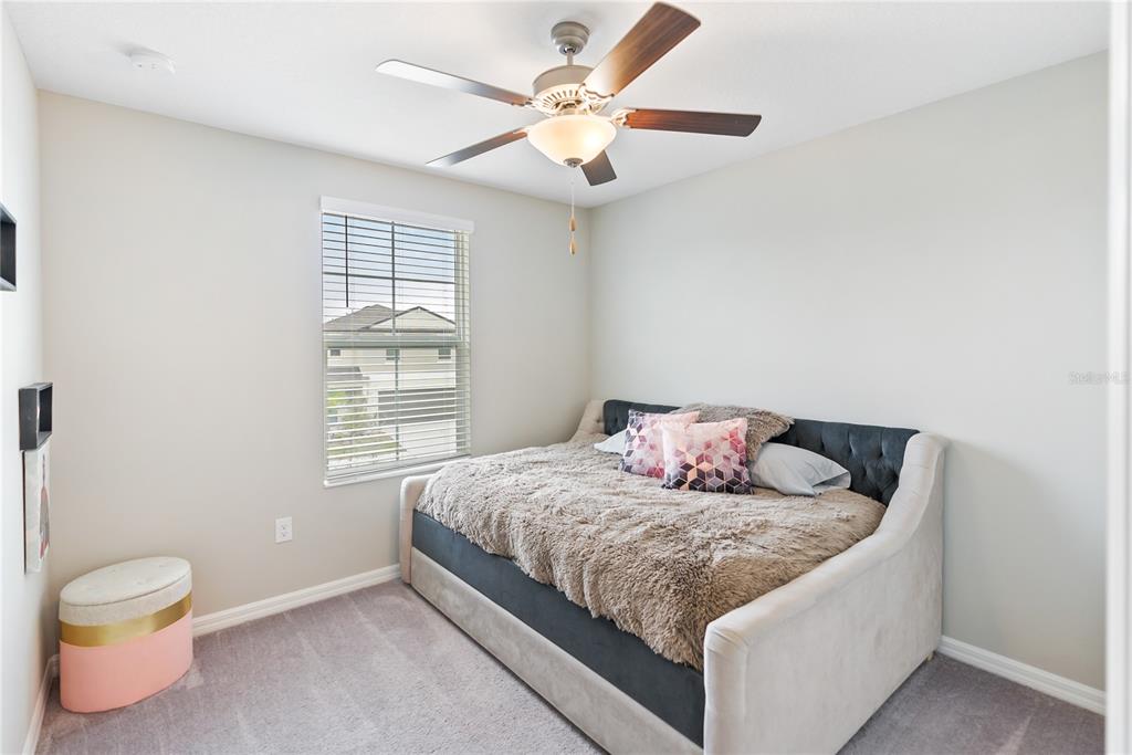 9313 Lemon Drop Loop Ruskin, FL 33573 - Photo 16 of 29 a bedroom with a bed and a window