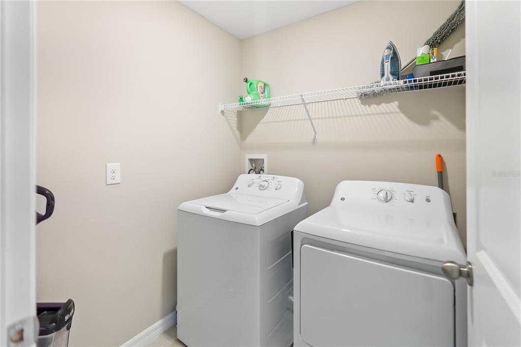 9313 Lemon Drop Loop Ruskin, FL 33573 - Photo 18 of 29 a utility room with dryer and washer