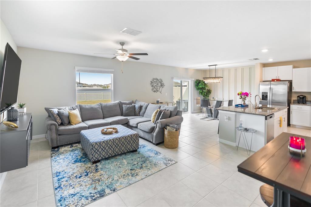9313 Lemon Drop Loop Ruskin, FL 33573 - Photo 5 of 29 a living room with furniture and a flat screen tv