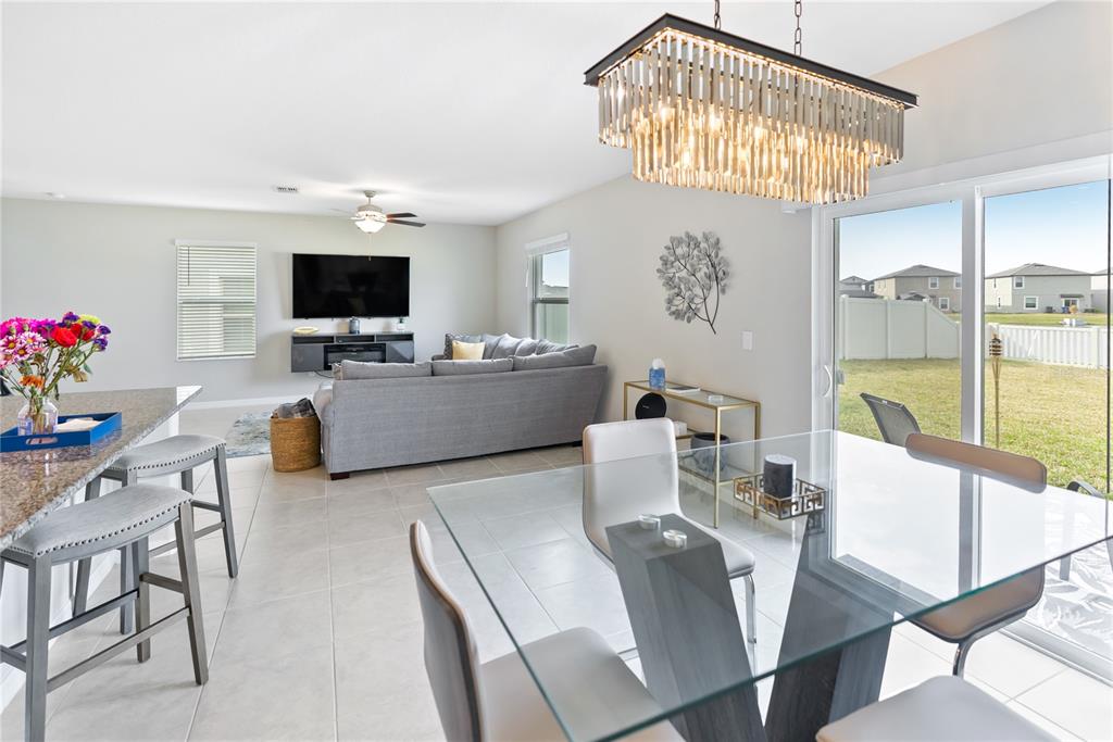 9313 Lemon Drop Loop Ruskin, FL 33573 - Photo 6 of 29 a living room with furniture a flat screen tv and a large window