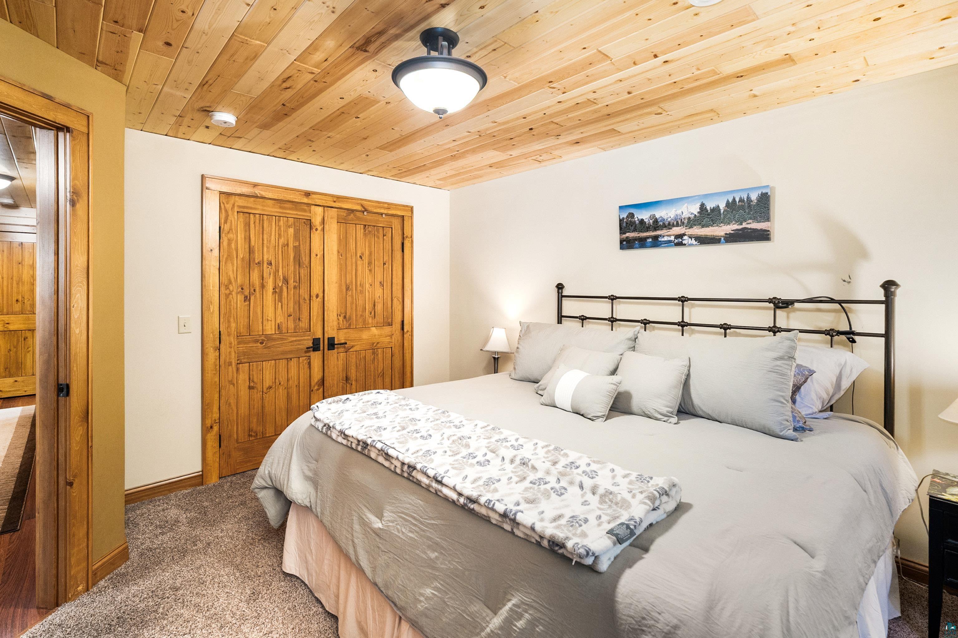 75 East Stark Road Esko, MN 55733 - Photo 40 of 87 Wood-finish planked ceiling with a flush-mount light fixture