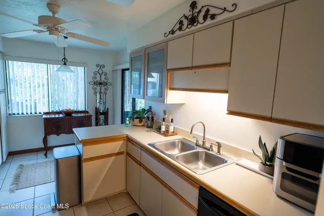 a kitchen with a sink appliances and cabinets
