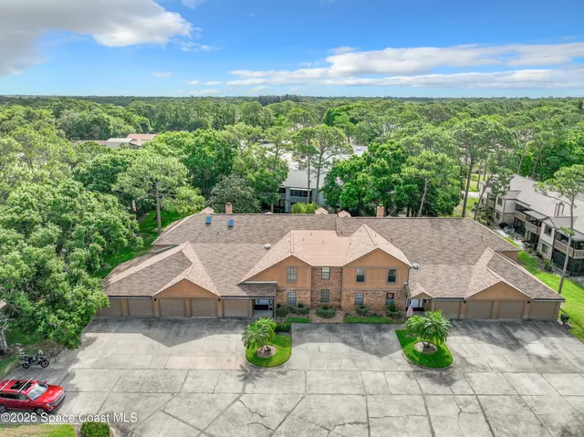 a view of a house with a garden and a yard