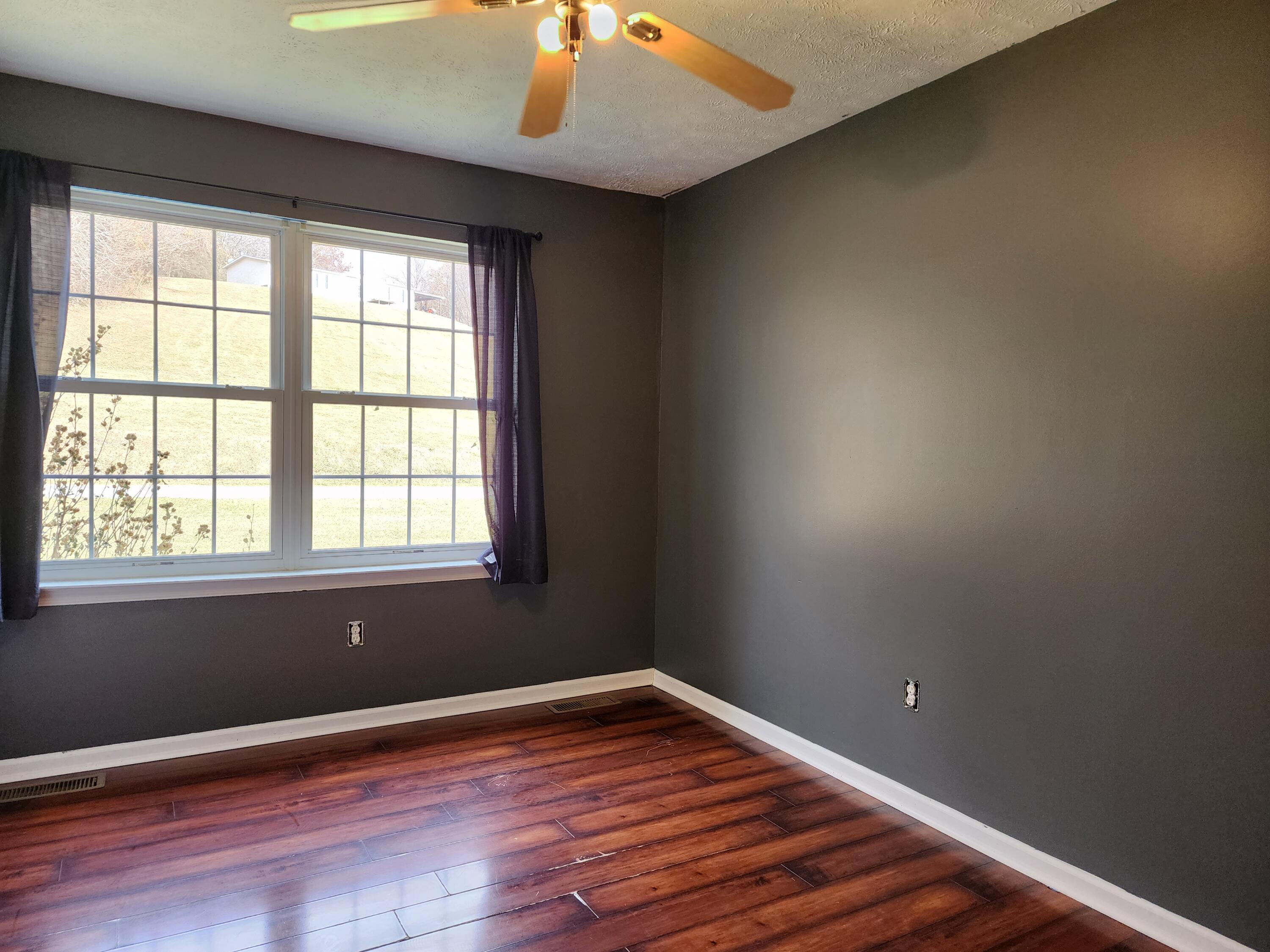 1189 Foothills Road Callaway, VA 24067 - Photo 14 of 21 an empty room with wooden floor and windows