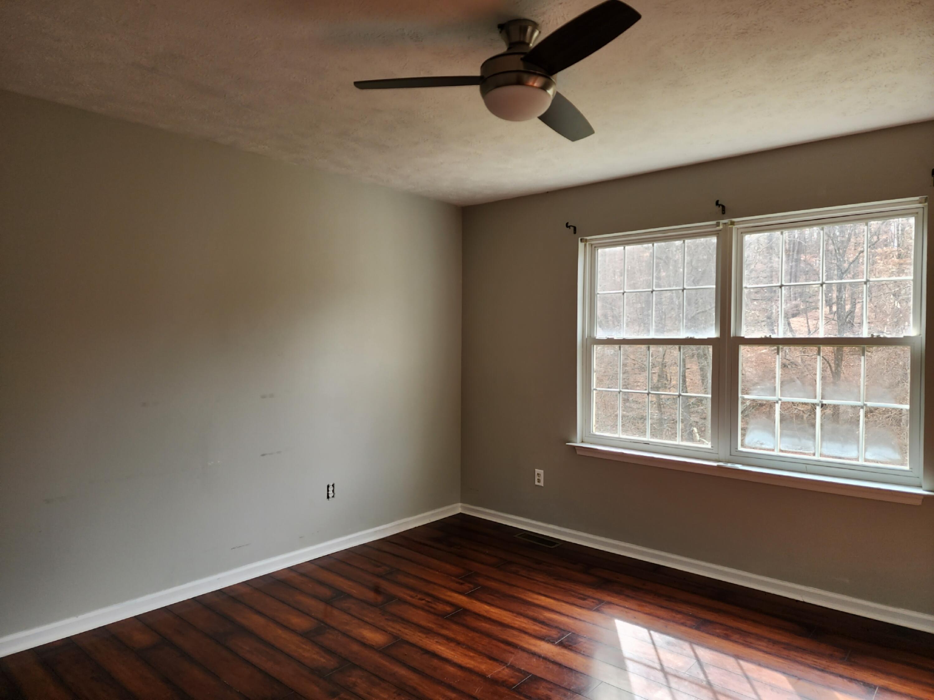 1189 Foothills Road Callaway, VA 24067 - Photo 15 of 21 an empty room with wooden floor and windows