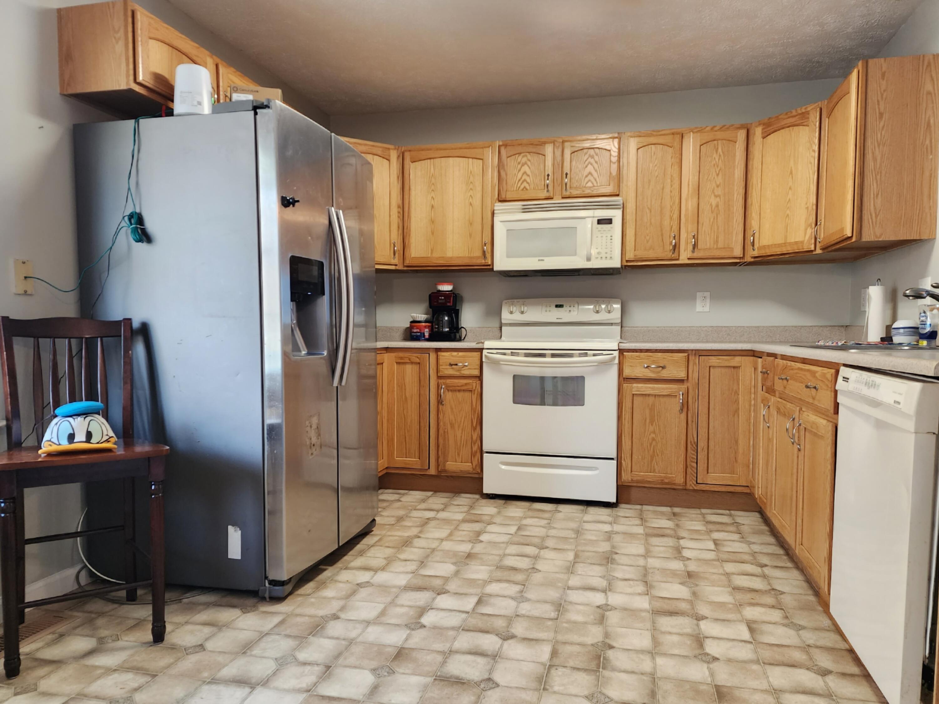 1189 Foothills Road Callaway, VA 24067 - Photo 7 of 21 a kitchen with stainless steel appliances granite countertop a stove a sink dishwasher a refrigerator and cabinets with wooden floor