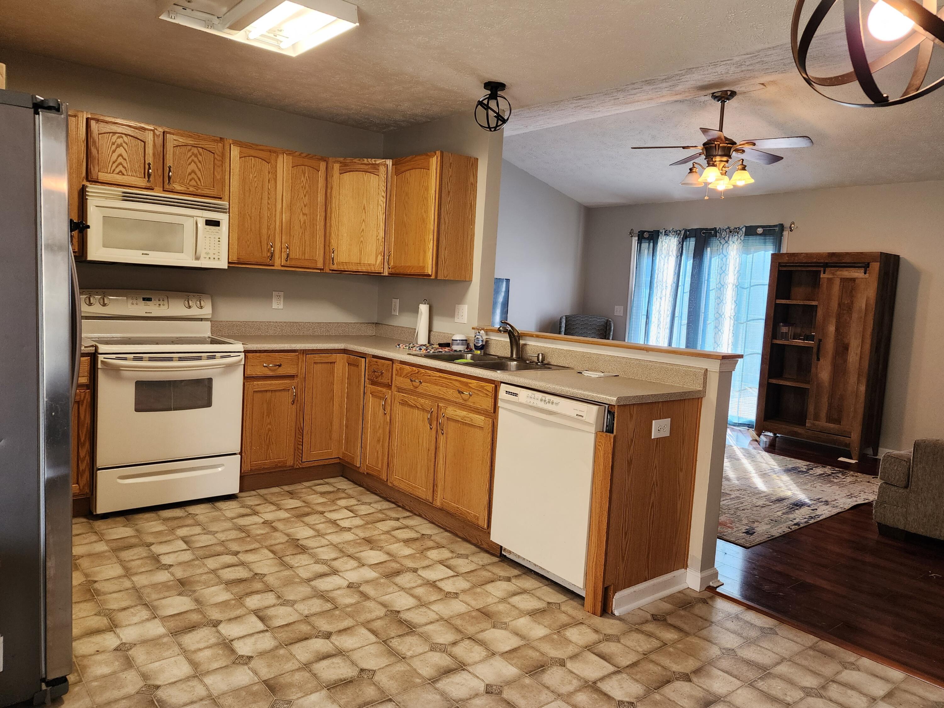 1189 Foothills Road Callaway, VA 24067 - Photo 8 of 21 a kitchen with stainless steel appliances granite countertop a sink stove and refrigerator