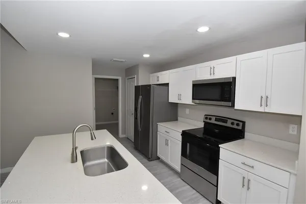 a kitchen with a sink a stove and refrigerator