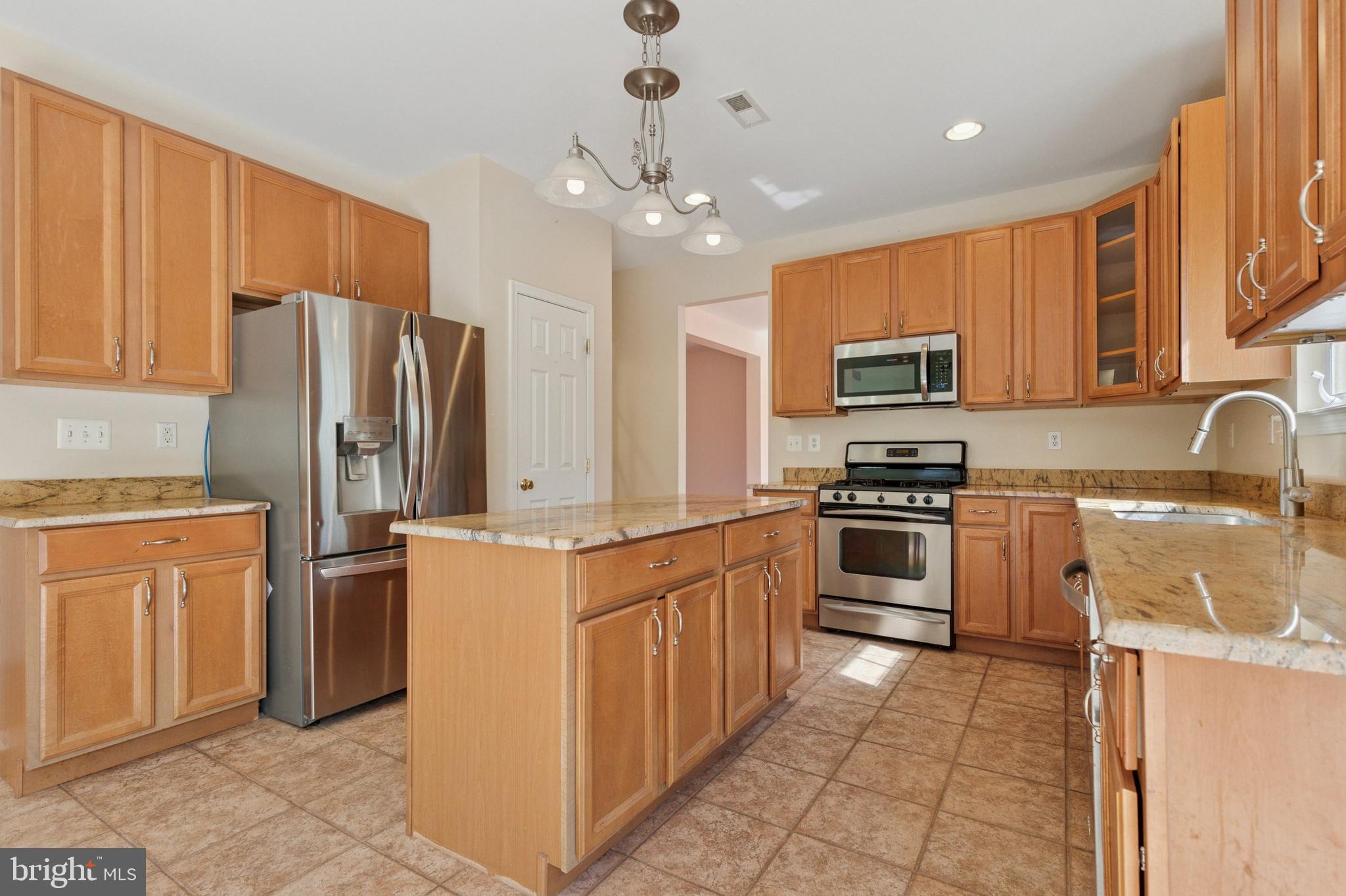 456 Windy Hill Road Gilbertsville, PA 19525 - Photo 11 of 46 a kitchen with stainless steel appliances a refrigerator stove microwave and sink