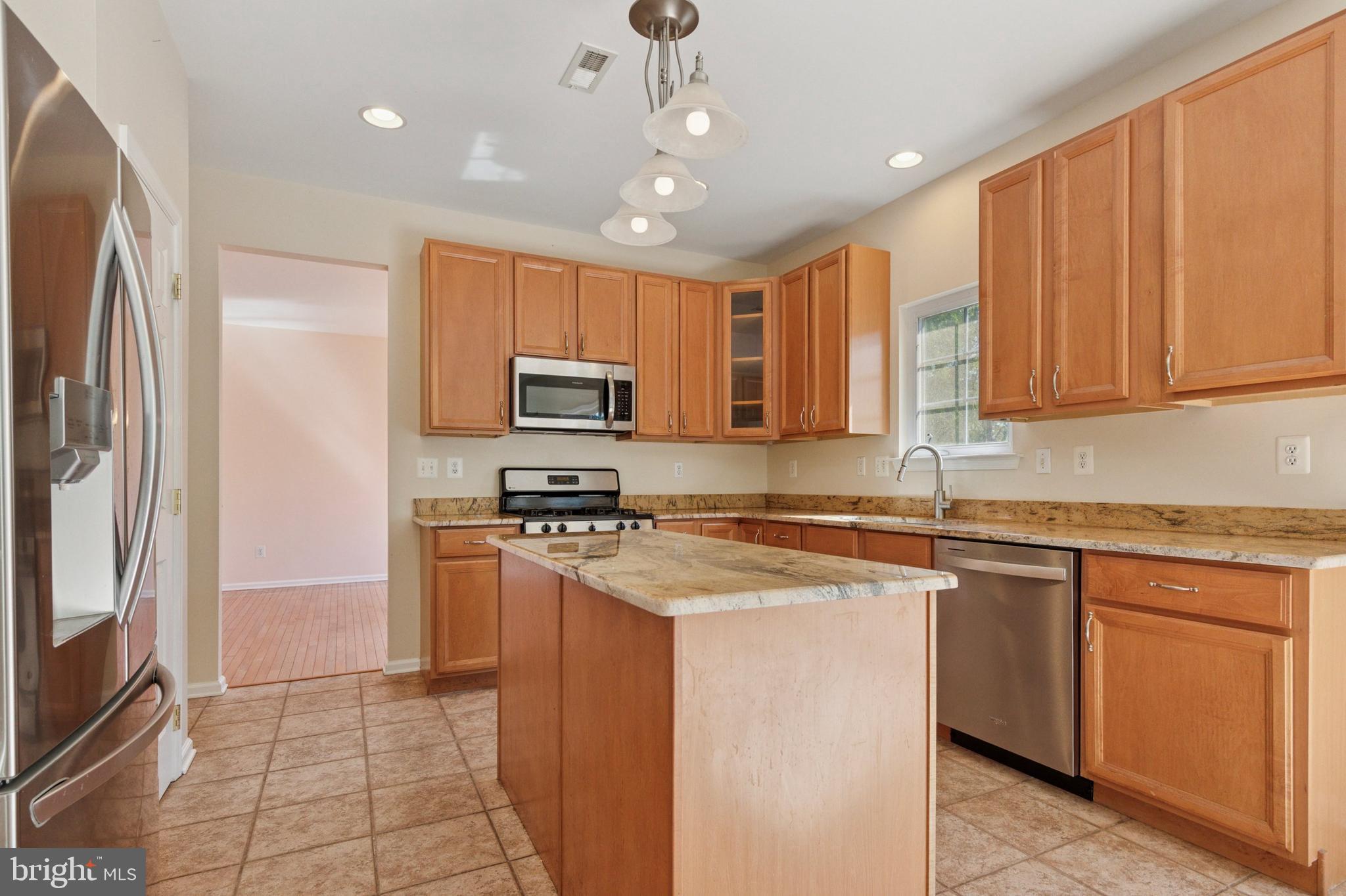 456 Windy Hill Road Gilbertsville, PA 19525 - Photo 12 of 46 a kitchen with stainless steel appliances granite countertop a refrigerator a stove top oven a sink and dishwasher