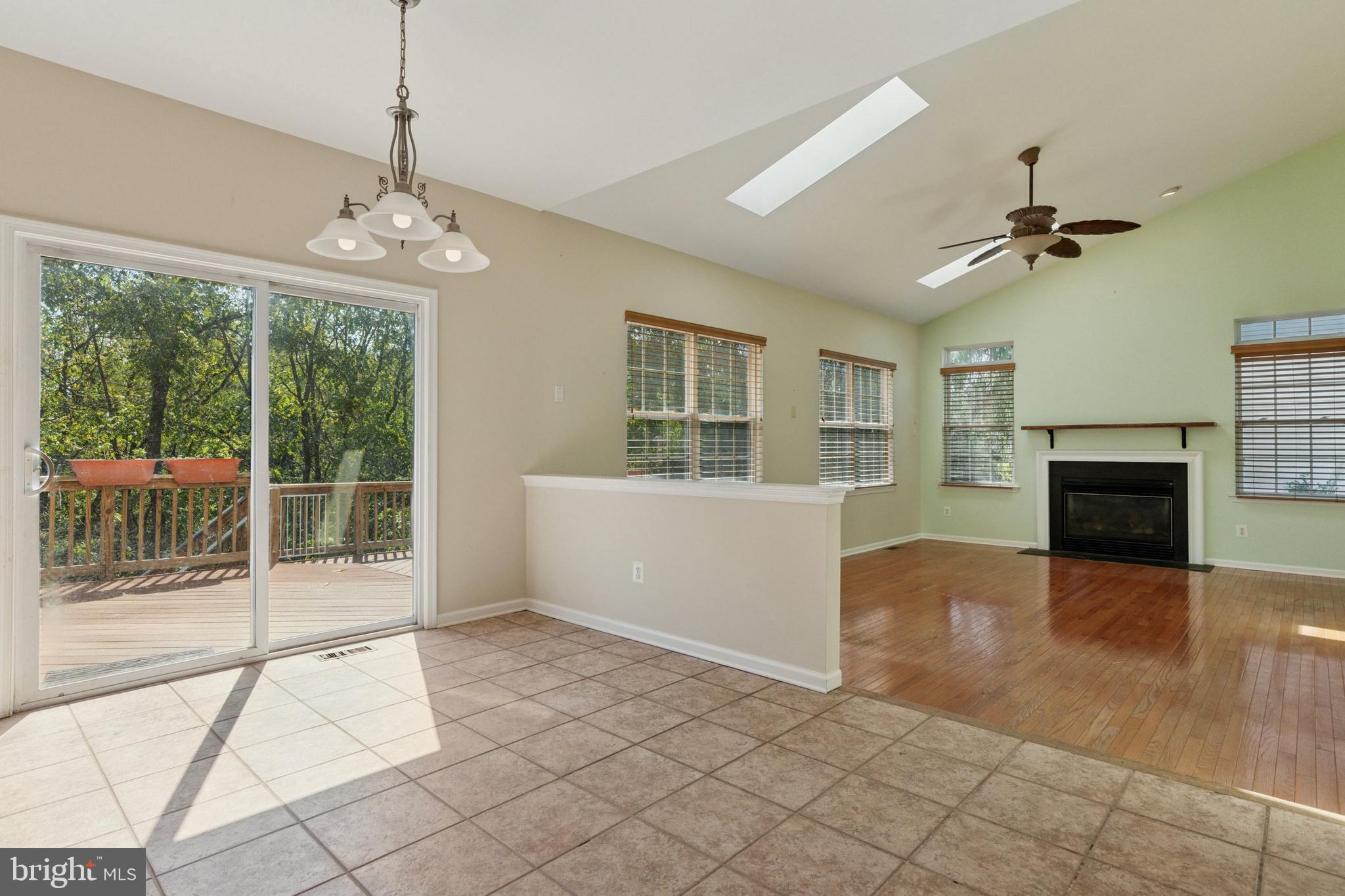 456 Windy Hill Road Gilbertsville, PA 19525 - Photo 15 of 46 a view of an empty room with a fireplace and a chandelier