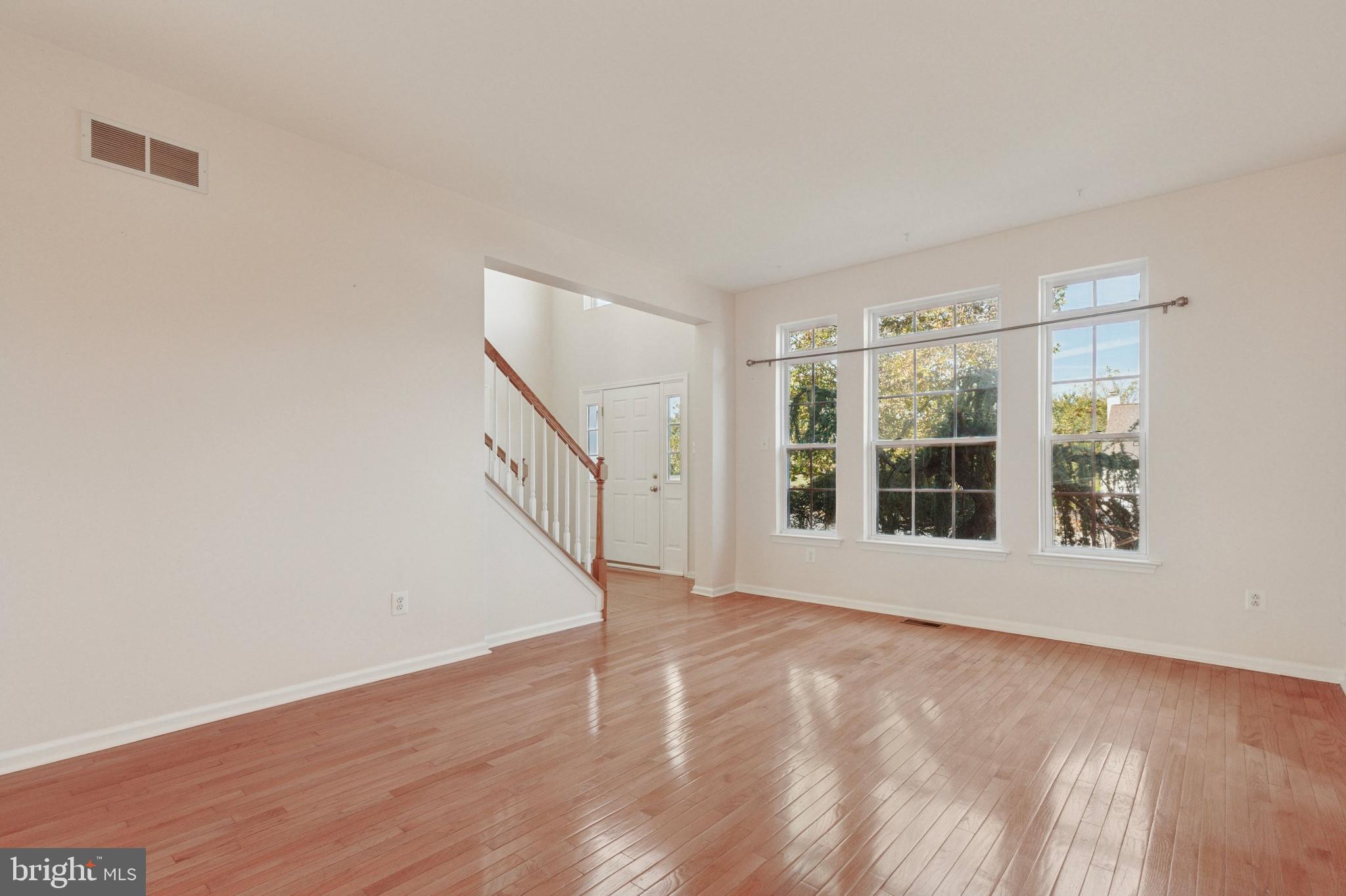 456 Windy Hill Road Gilbertsville, PA 19525 - Photo 17 of 46 a view of an empty room with wooden floor and a window