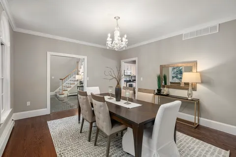 a view of a dining room with furniture and wooden floor