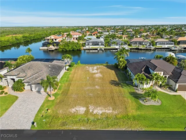 an aerial view of a house with a garden and lake view