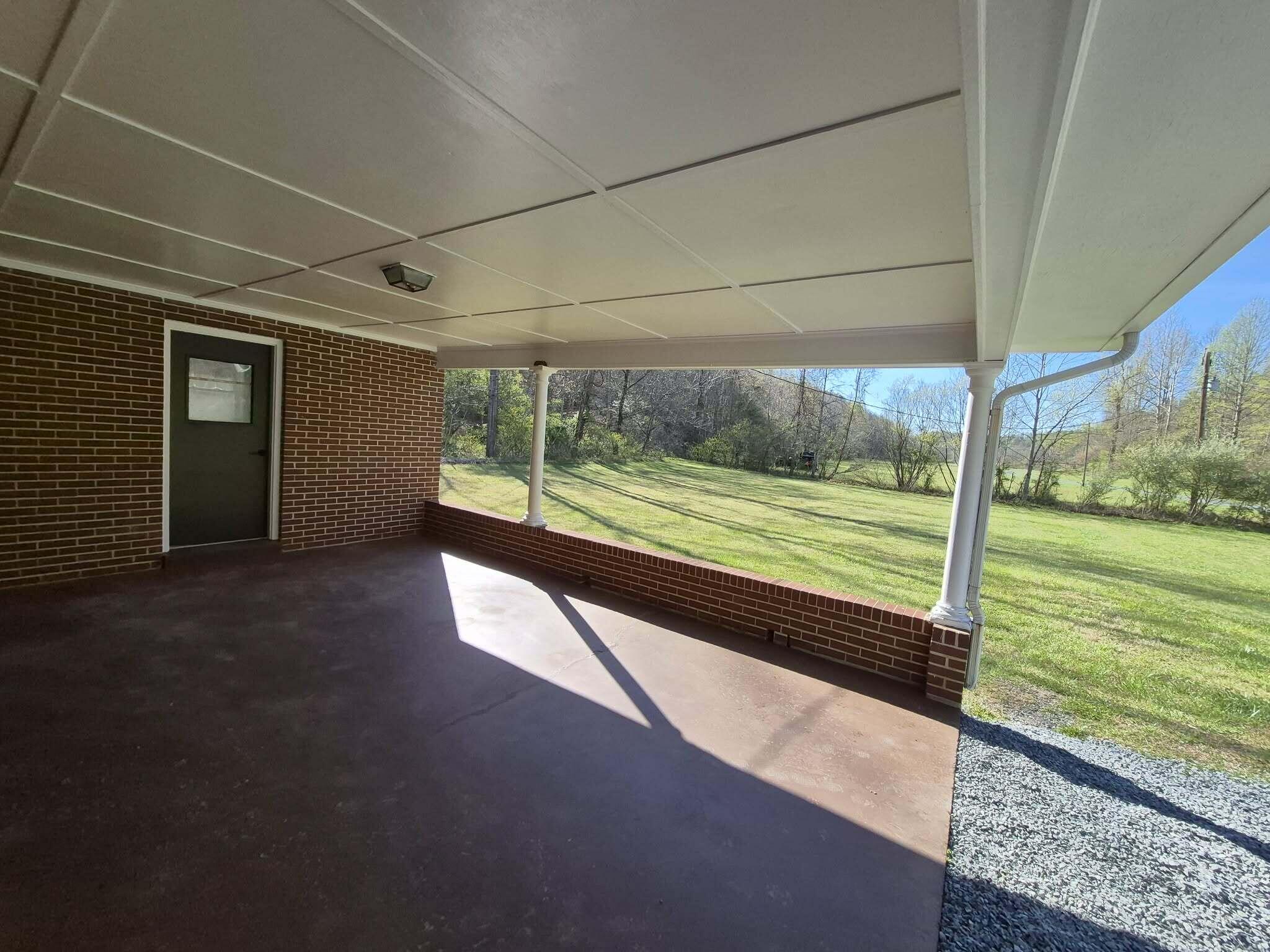 1232 Prillaman Switch Road Ferrum, VA 24088 - Photo 16 of 50 a view of a porch with wooden floor and fence