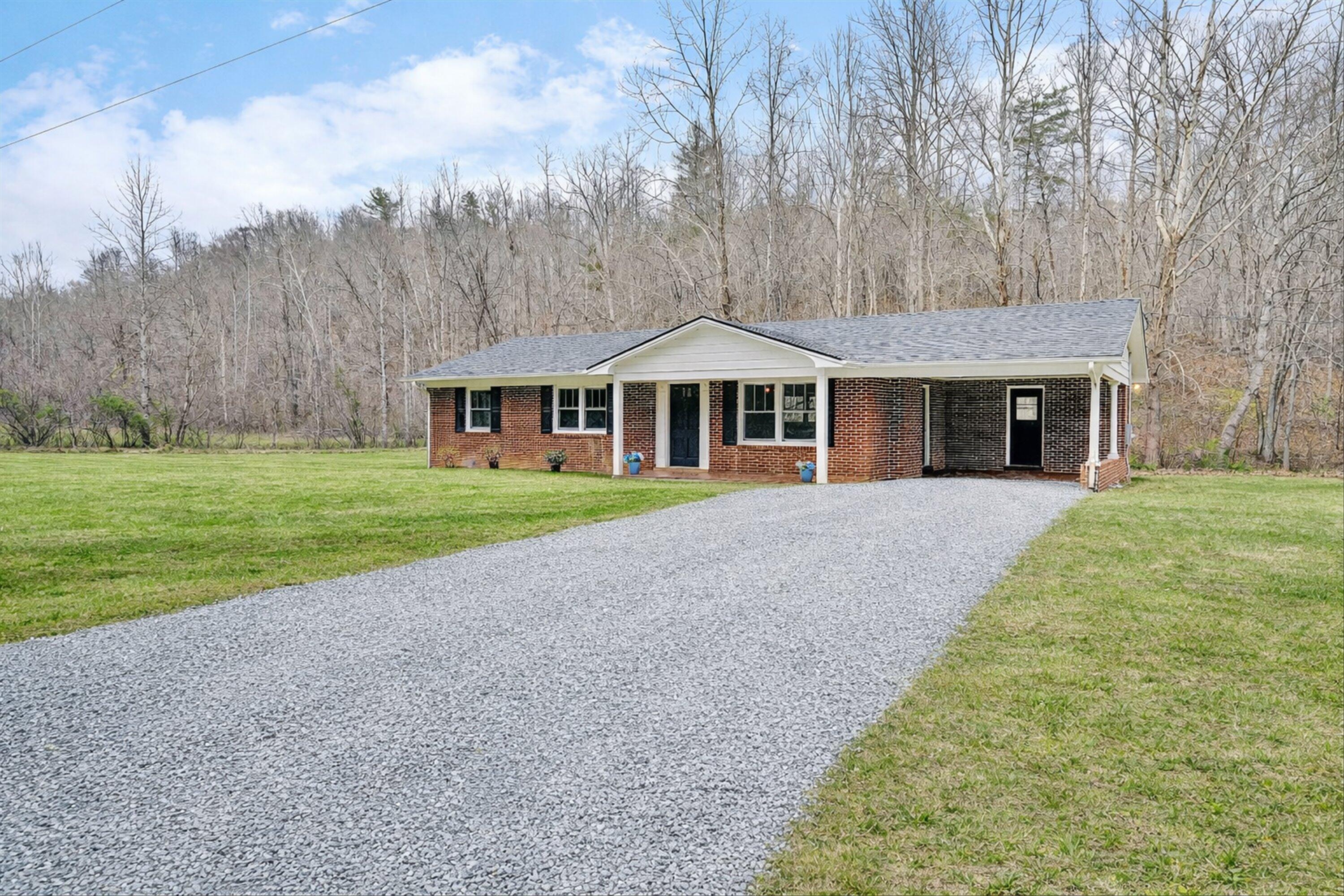 1232 Prillaman Switch Road Ferrum, VA 24088 - Photo 2 of 50 a front view of a house with a yard and trees