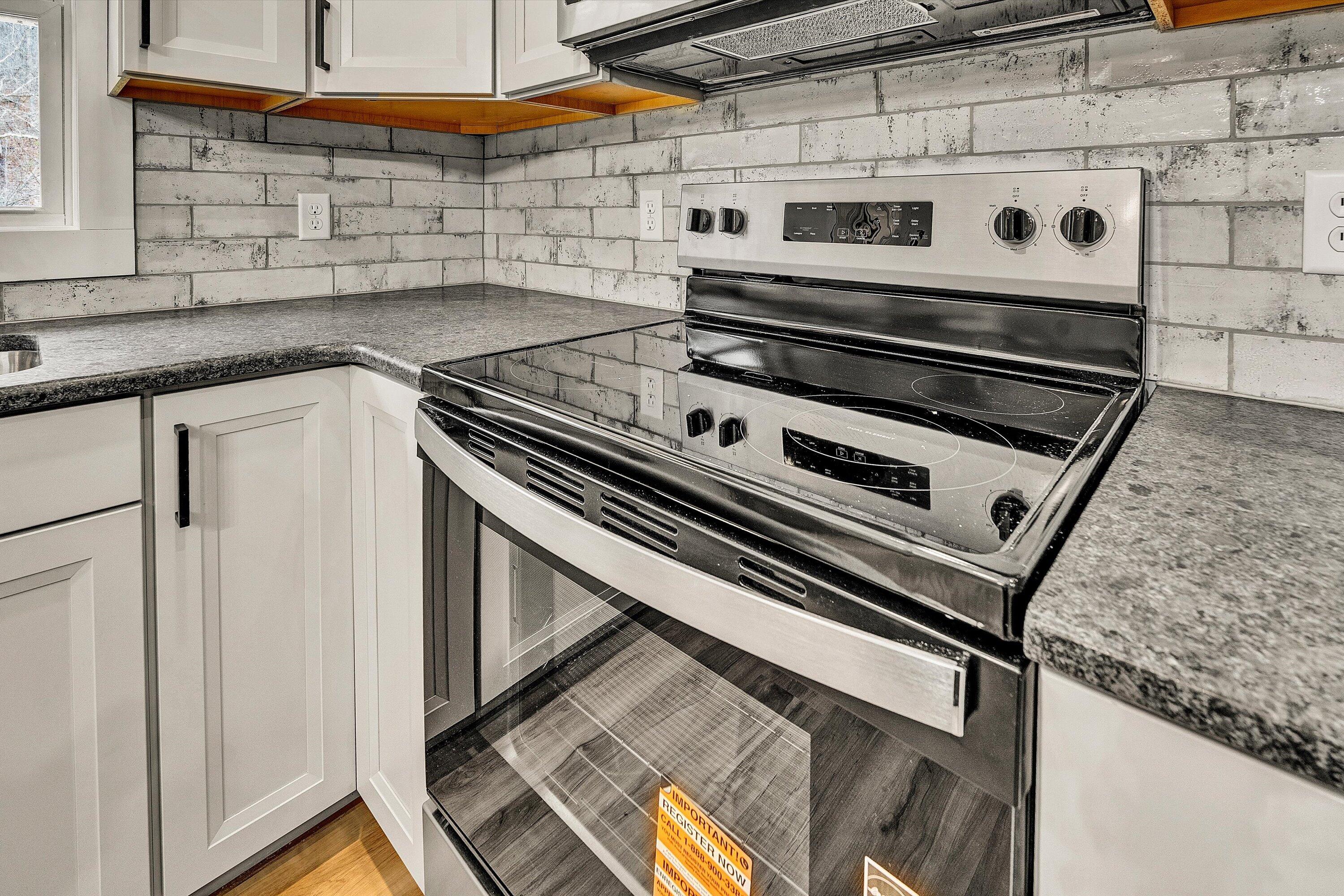 1232 Prillaman Switch Road Ferrum, VA 24088 - Photo 26 of 50 a stove top oven sitting inside of a kitchen