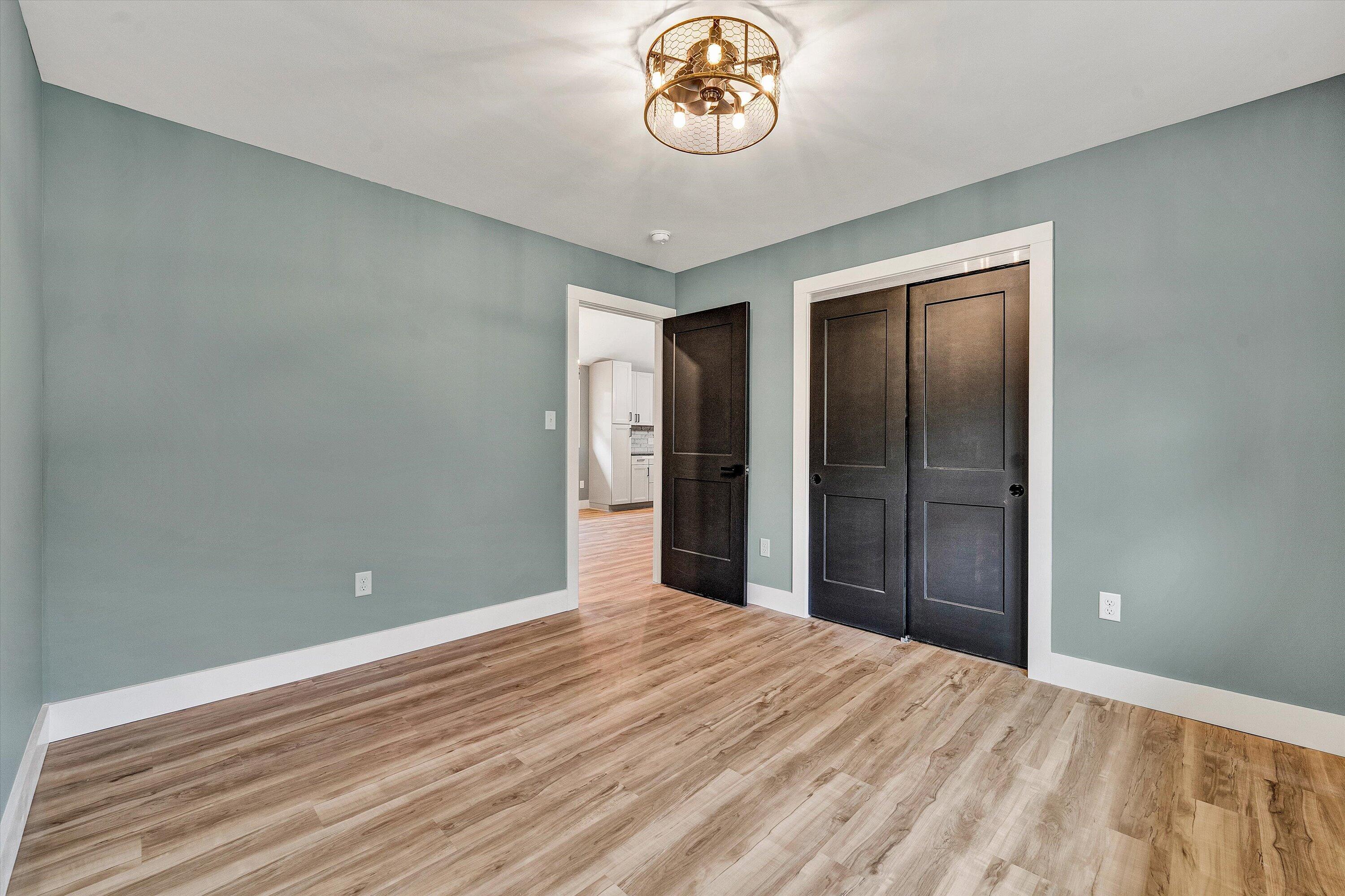 1232 Prillaman Switch Road Ferrum, VA 24088 - Photo 29 of 50 a view of a room with wooden floor and a ceiling fan