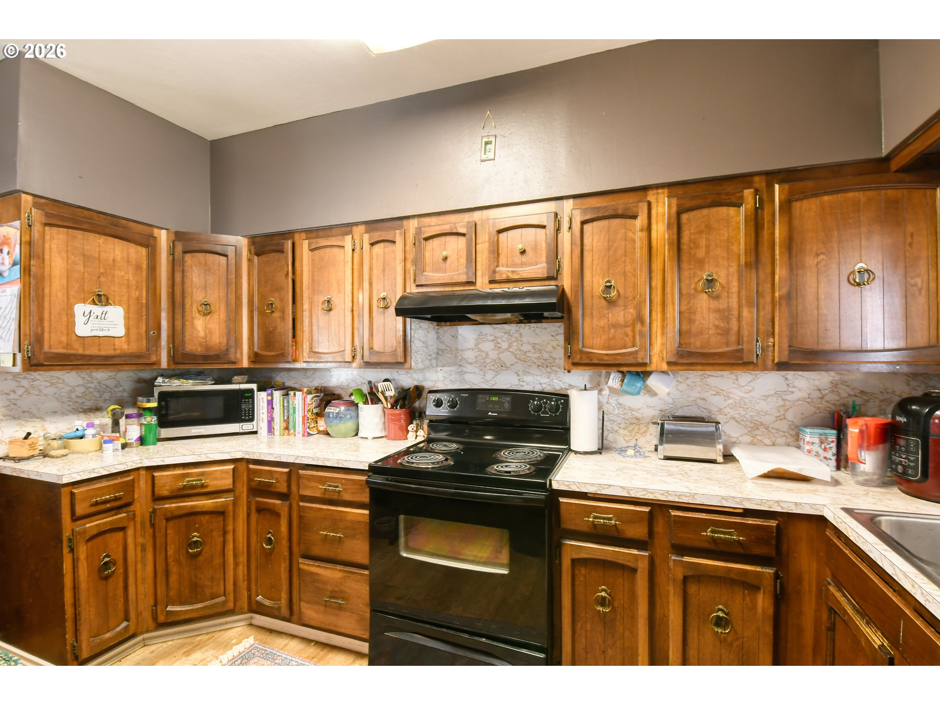 607 Southwest Court Avenue Pendleton, OR 97801 - Photo 14 of 48 a kitchen with a sink a stove cabinets and a window