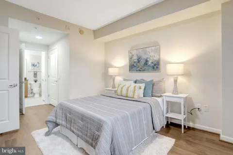 a bedroom with a bed and a painting on the wall