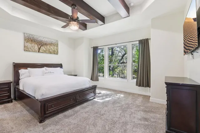 a spacious bedroom with a bed and a table