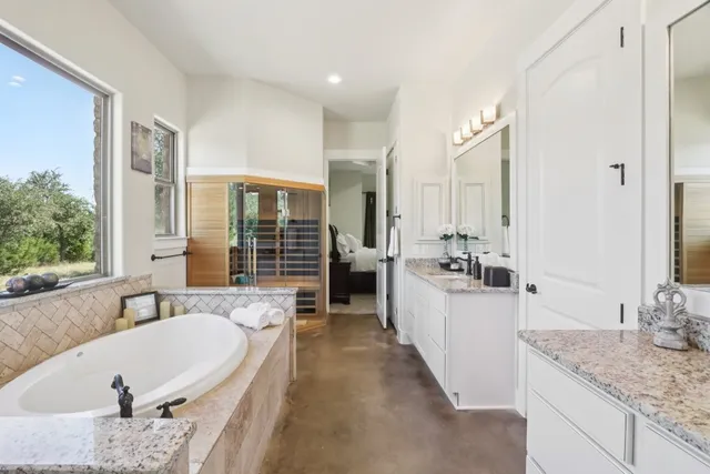 a large spacious bathroom with a granite countertop tub sink and mirror