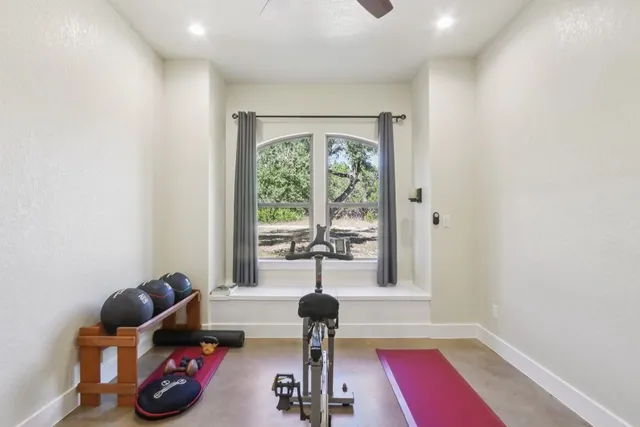 a room with lots of potted plants and a window