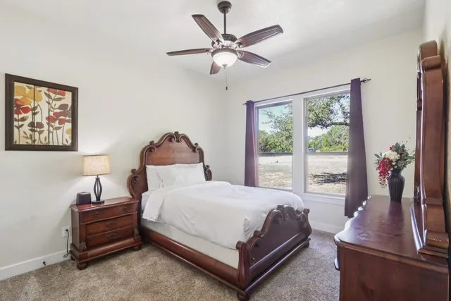 a bedroom with a bed and a large window