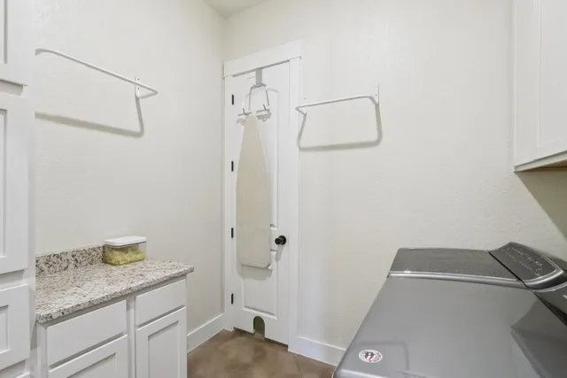 a bathroom with a granite countertop sink a toilet and shower