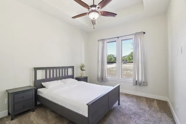 a bed sitting in a bedroom next to a window