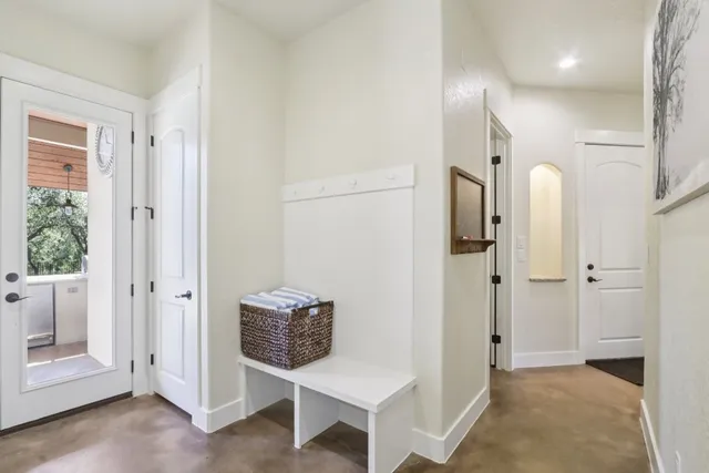 a view of a hallway with wooden floor and entryway