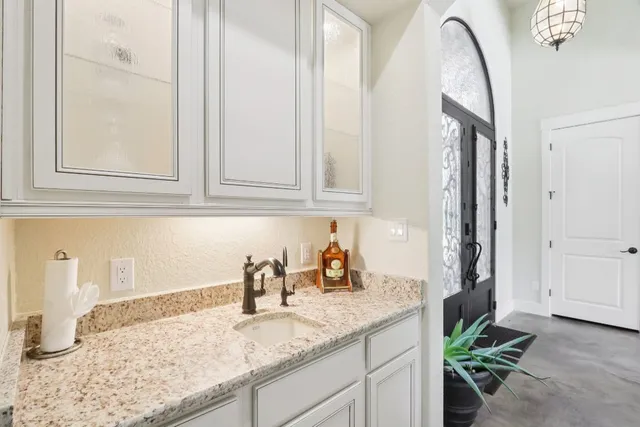a kitchen with stainless steel appliances granite countertop a sink and cabinets