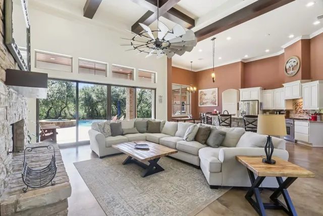 a living room with patio furniture and a large window