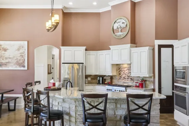 a view of a dining room with furniture and a chandelier