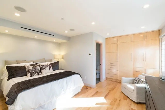 a bedroom with a large bed and a couch