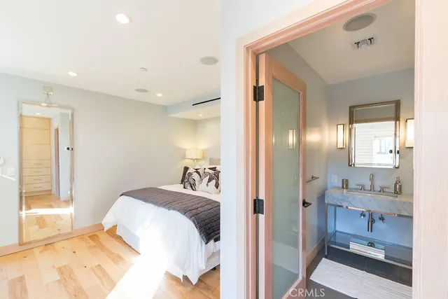 a bedroom with a bed and a mirror